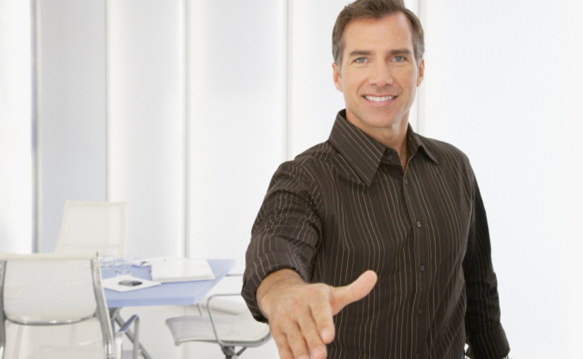 Interviewer welcoming candidate with handshake