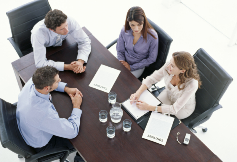 4 people at table to introduce accredited programmes